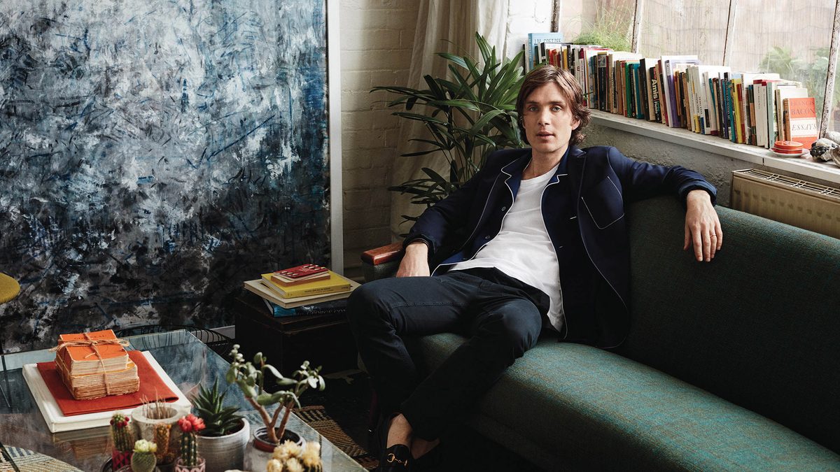Cillian Murphy on a forest green couch.
