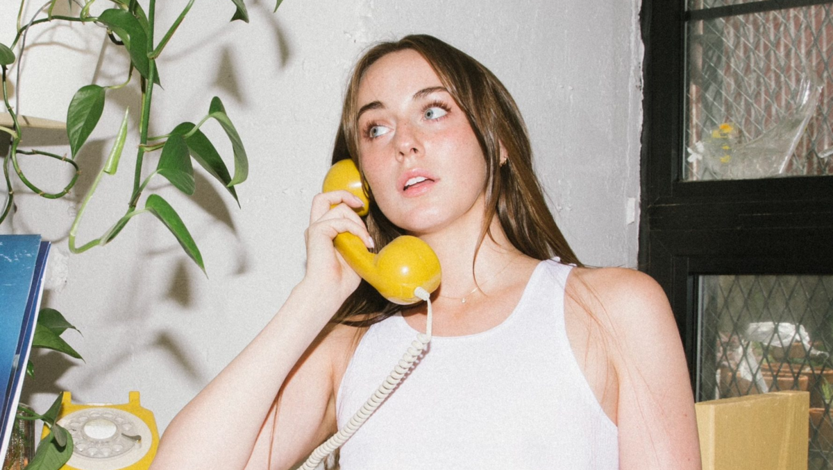 Tori Darking talking on a yellow phone.