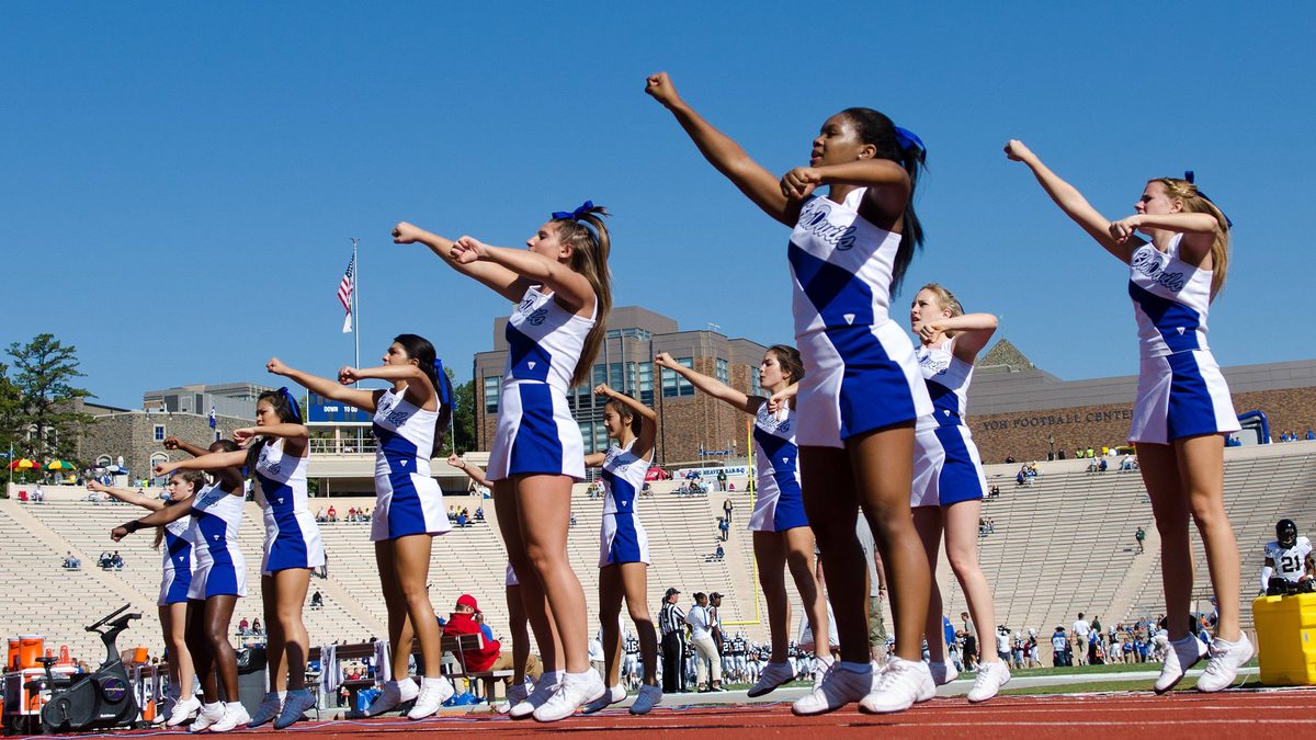 Duke cheerleaders cheering at a college football game.