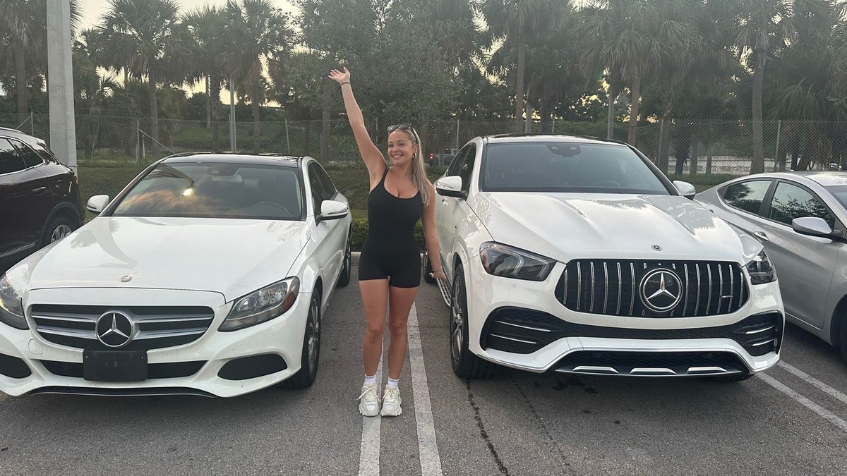 Kylie Hammonds standing next to her Mercedes-Benz
