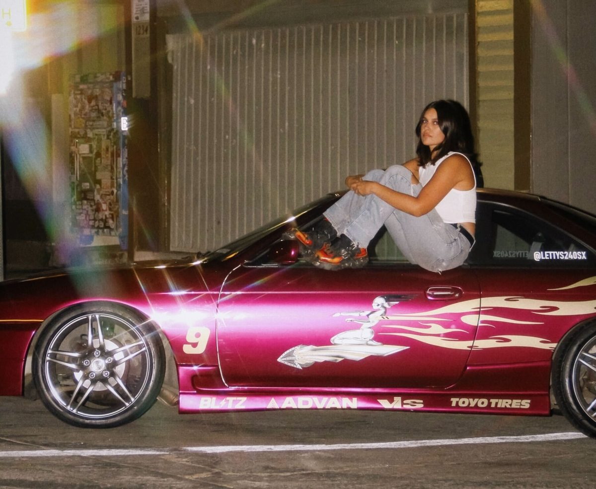 Photographer Hailey Magoon cosplays as "Letty Ortiz" with her Nissan 240SX from The Fast and the Furious.