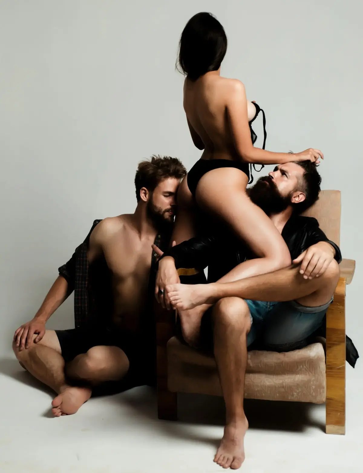 Three people about to engage in group sex