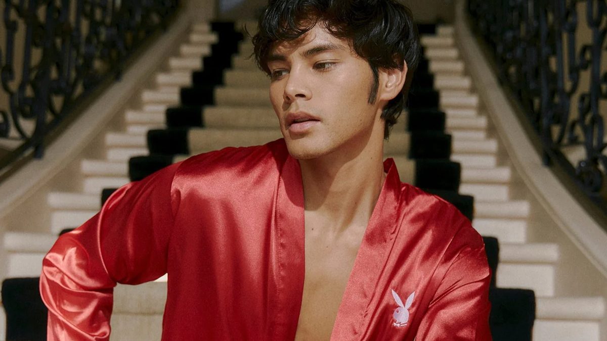 Man wearing Playboy satin robe.