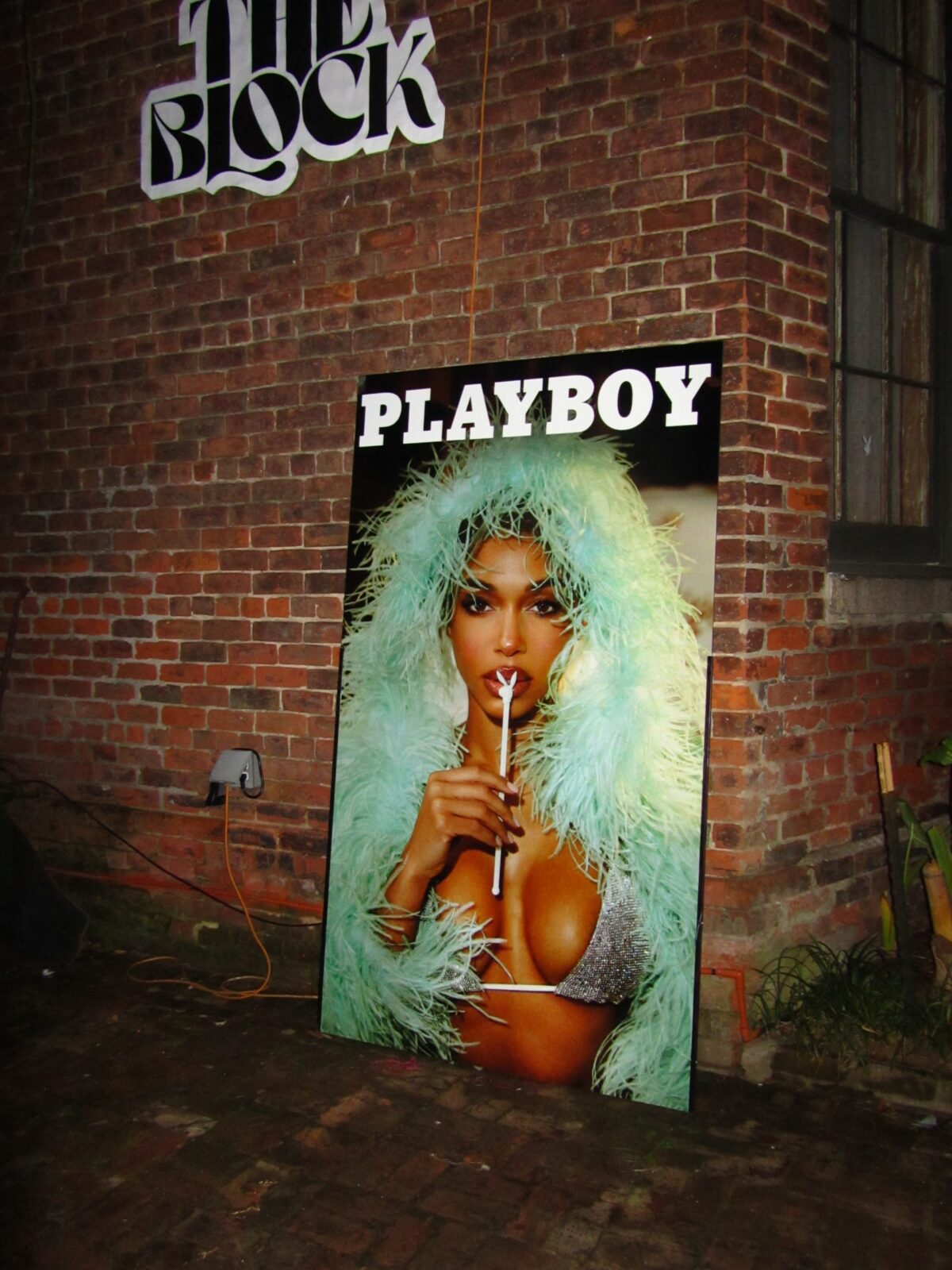 Poster of the 2025 PLAYBOY issue next to the entrance at The Block