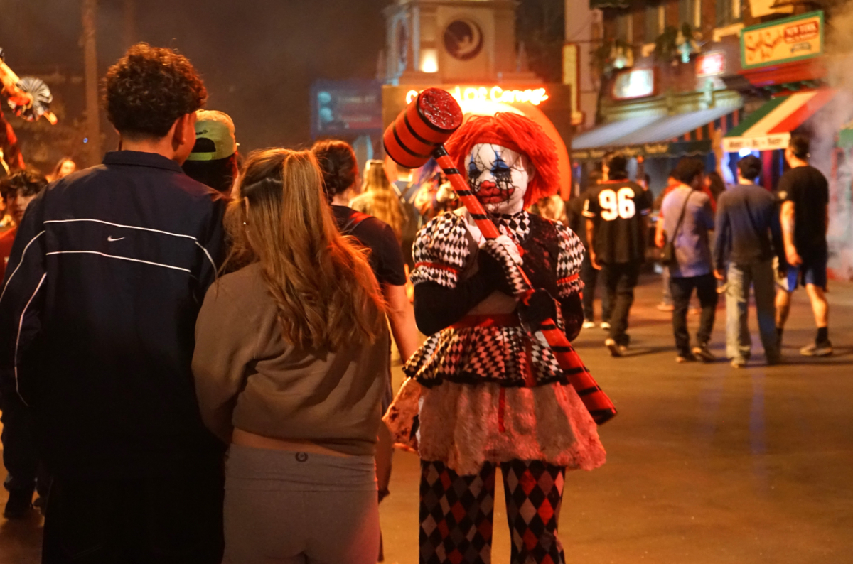 A staff member of Universal Studios Hollywood, in Halloween costume, interacts with tourists during the 2025 Halloween Horror Nights, in Los Angeles, California, the United States, on Sept. 27, 2025. Universal Studios Hollywood in the U.S. city of Los Angeles is captivating visitors with its annual Halloween Horror Nights, one of Southern California's premier Halloween-themed events. Renowned for its elaborate make-up, costuming, and immersive set designs, Universal Studios Hollywood has become a top destination for thrill-seekers during the Halloween season. This year's Halloween Horror Nights will run through Nov. 2. (Photo by Zeng Hui/Xinhua via Getty Images)